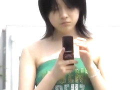 Black-haired pretty bimbo is texting her boyfriend in the middle of sharking