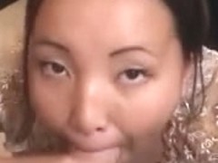 Cute Oriental girlfriend giving blow job